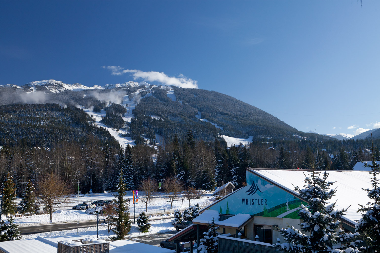 View from a Glacier Lodge suite across snow-covered Whistler village toward the ski runs of Whistler Mountain